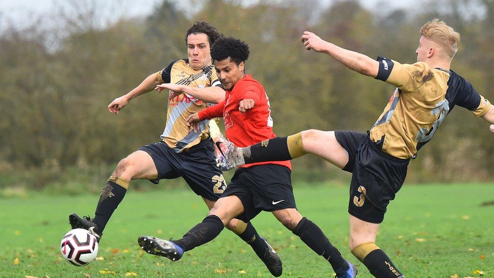 Grassroots football players in a game