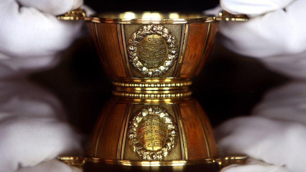 A member of staff at Abbotsford house holds The Waterloo Tree Quaich on March 19, 2010 in Abbotsford in Scotland