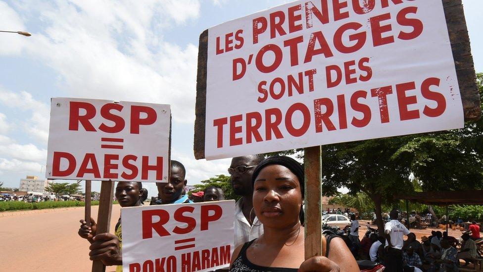 A protester holds a sign condemning the RSP