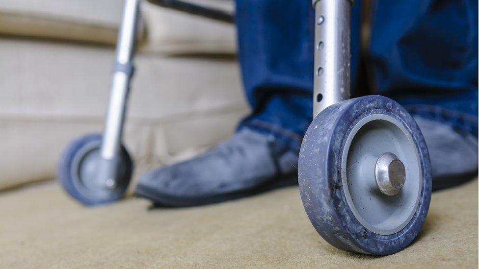 Man using rollator (stock photo)