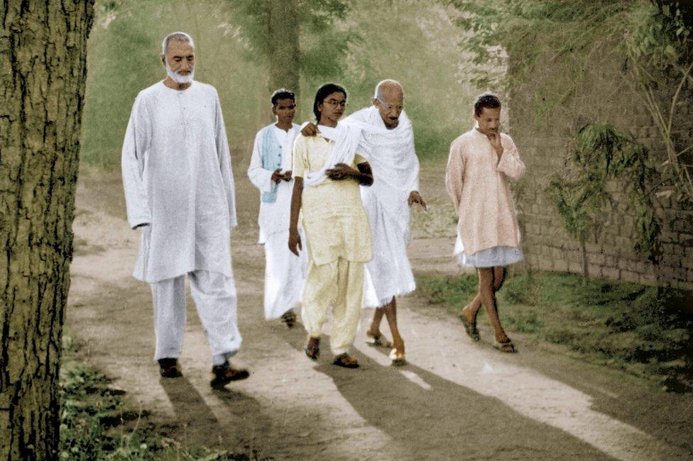 Mahatma Gandhi walking with his granddaughter Manu Gandhi and Khan Abdul Ghaffar Khan, Patna, Bihar, India, March 1947