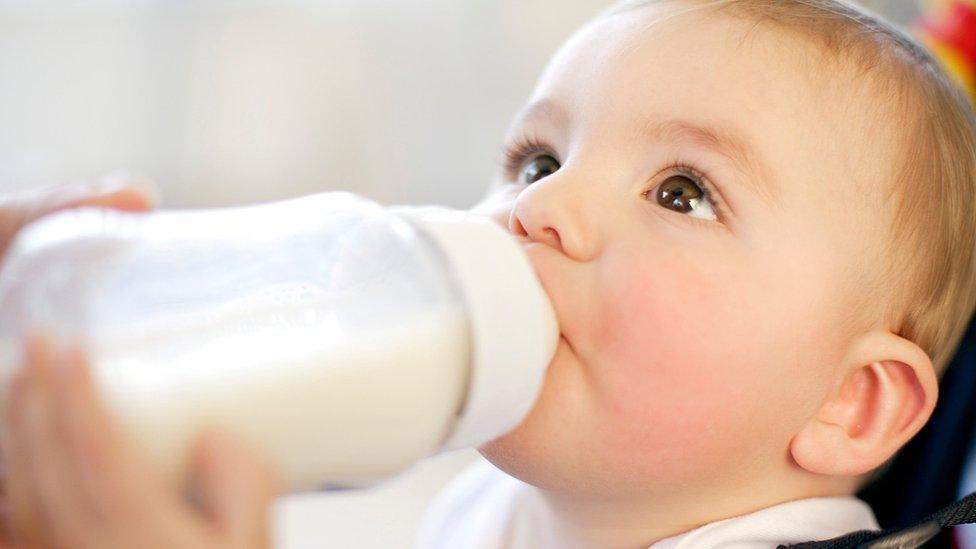 Baby drinking milk from a bottle