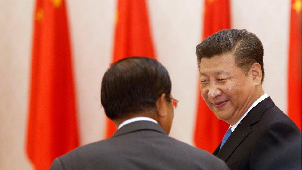 Chinese President Xi Jinping (right), smiles next to Cambodian Prime Minister Hun Sen at the Prime Minister"s office in Phnom Pen