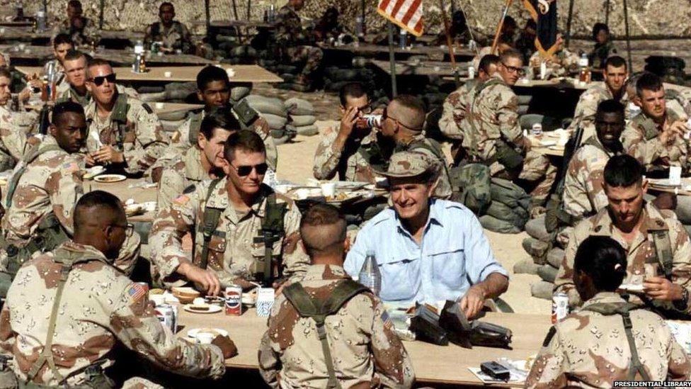 George HW Bush celebrating Thanksgiving with the troops in Saudi Arabia during Desert Shield, November 22, 1990