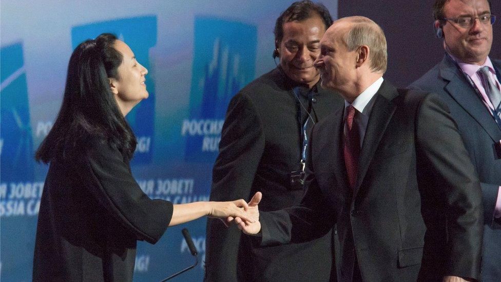 Russia's President Vladimir Putin (R) greets Meng Wanzhou, Executive Board Director of the Chinese technology giant Huawei, during a session of the VTB Capital Investment Forum "Russia Calling!" in Moscow in 2014