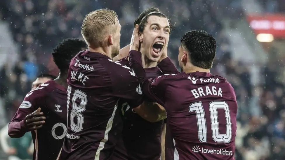 Hearts midfielder Tomas Magnusson is mobbed by team-mates
