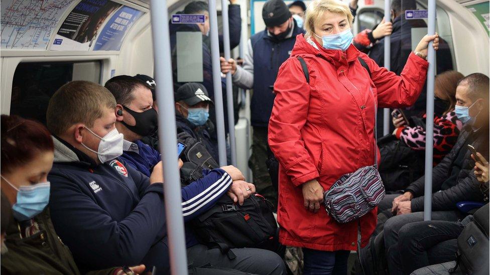 Commuters wearing masks