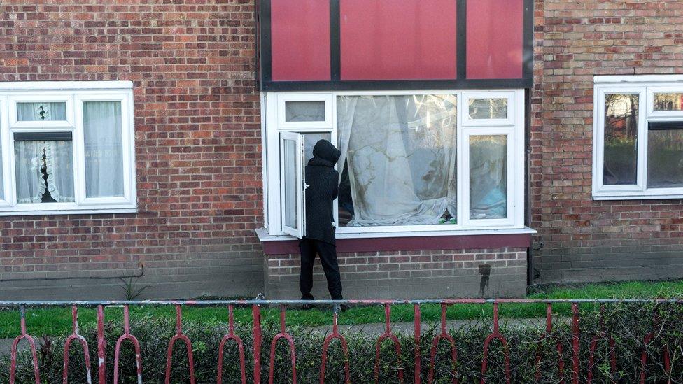 Hooded person outside window in Ipswich