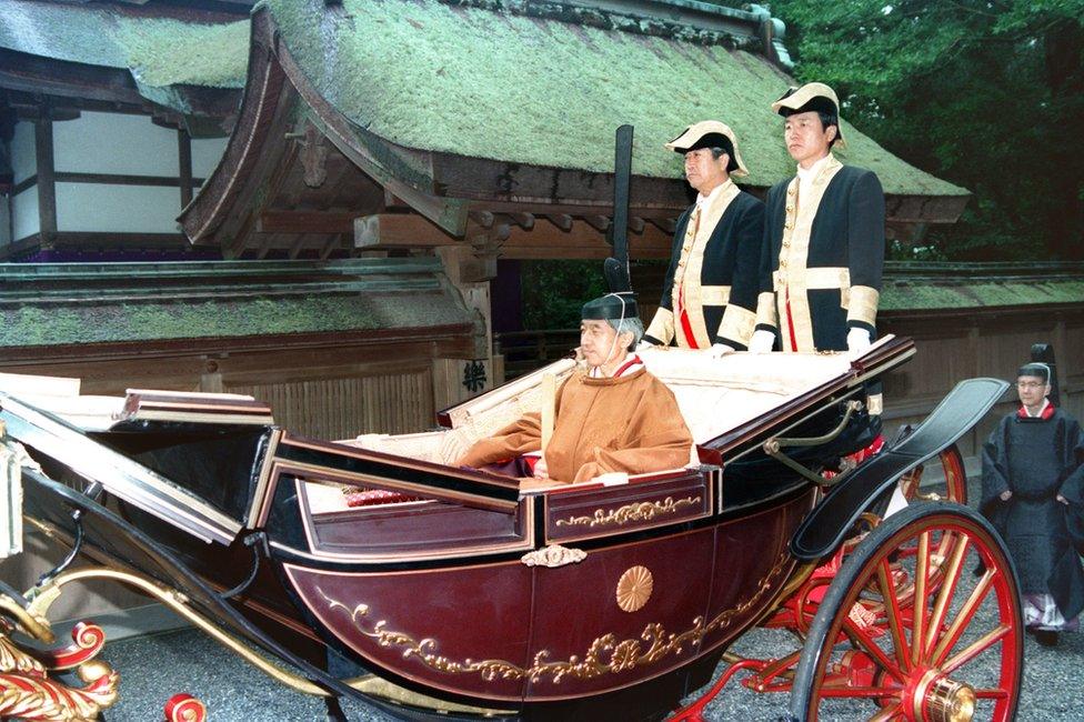 Japan's Emperor Akihito clad in ancient court robes is headed by a carriage for his enthronement at Ise Grand Shrine in Japan, 27 November 1990.