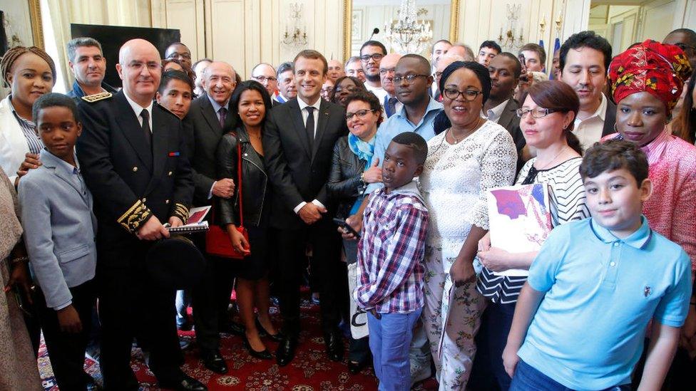 Macron standing with new citizens after the ceremony in Orleans