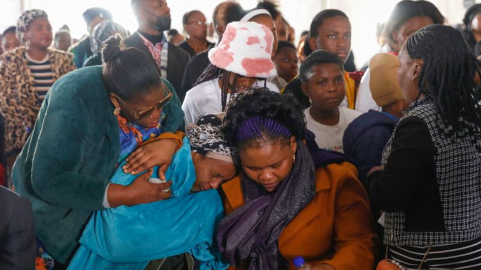 Women mourning at the funeral in East London, South Africa - 6 July 2022