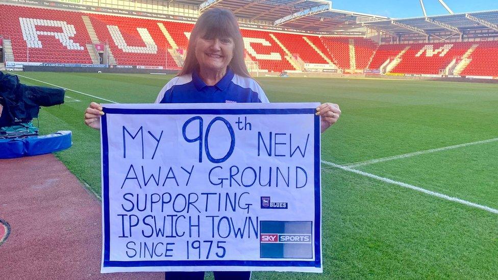 Angela Howarth holding a sign at Rotherham's New York Stadium