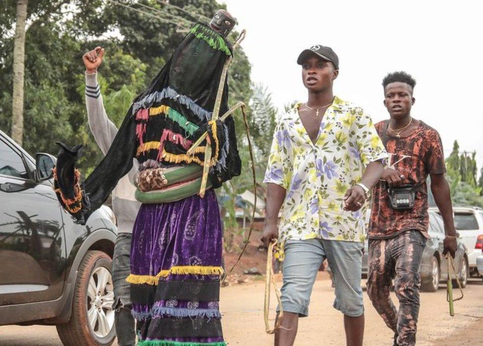 A masquerade group parading through the streets of Arondizuogu during the Ikeji Festival in Nigeria