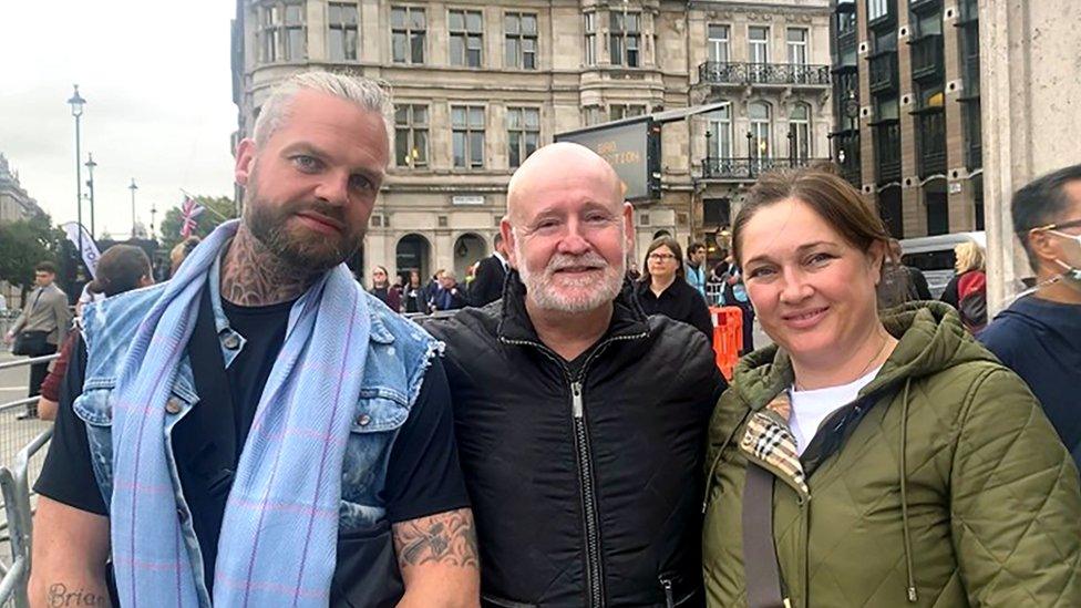 Three mourners in London after seeing the Queen lying in state