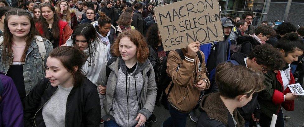 A student holds a banner during a protest against a proposed reform of the Baccalaureat system in March 2018