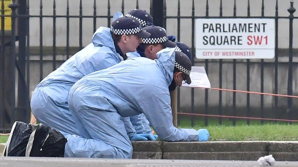 Police forensic officers in Parliament Square outside the Houses of Parliament in London