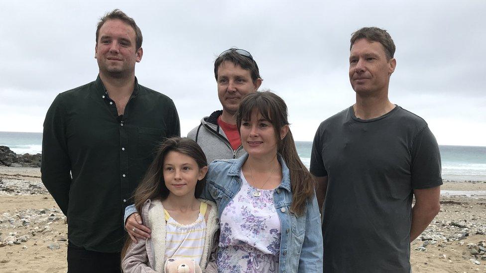 five people on a beach