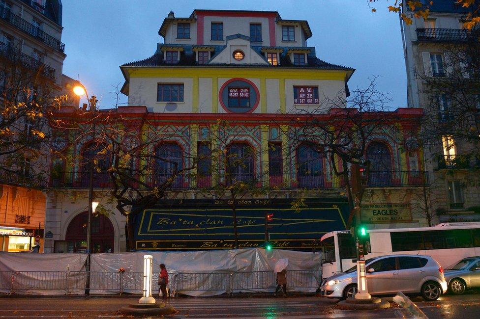 People walk past the Bataclan concert hall in Paris