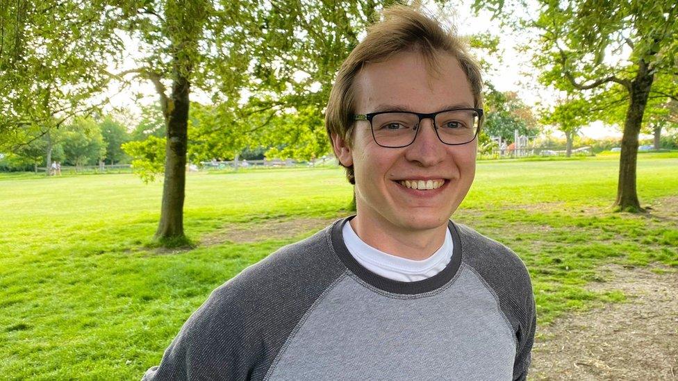 Election candidate James Crawford smiling as he stands in a park