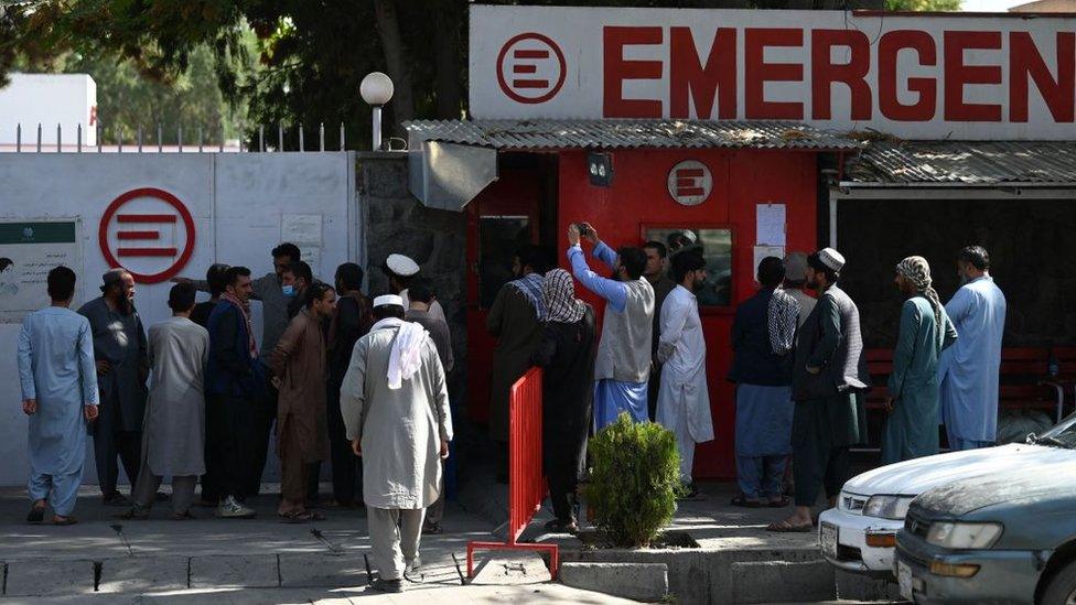 People gather to check on missing relatives a day after a twin suicide bombs attack