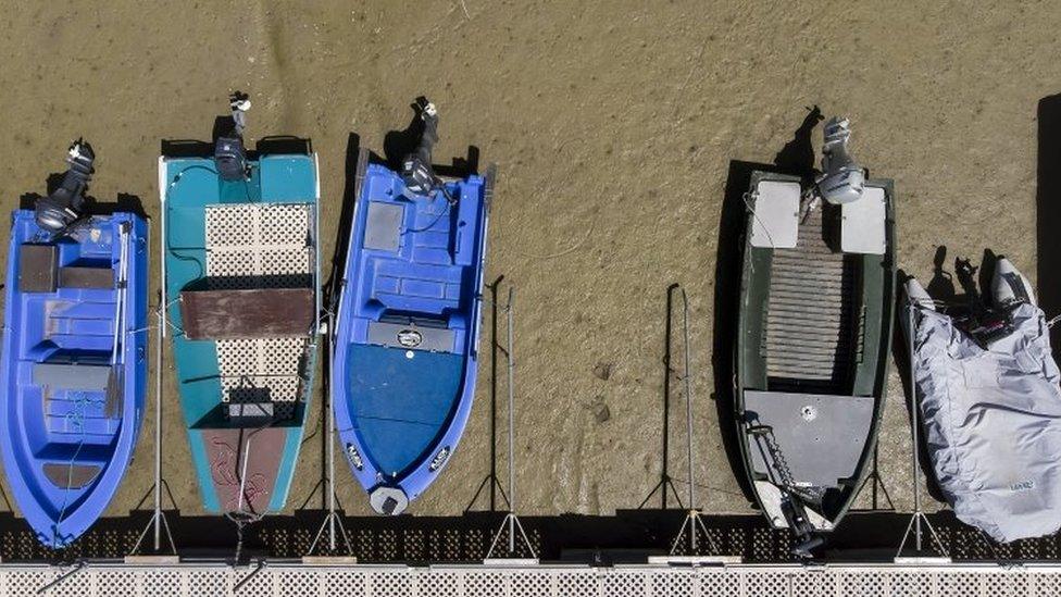 Boats on the dried out shore of Brenet Lake