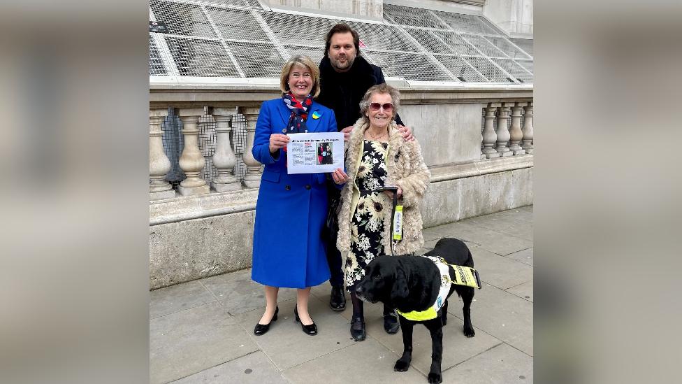 MP Anna Firth, BBC local radio presenter Justin Dealey, and Jill Allen-King with her guide dog Jagger