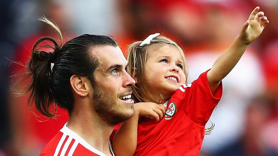 Gareth Bale celebrates with his daughter Alba Violet after beating Northern Ireland at Parc des Prin