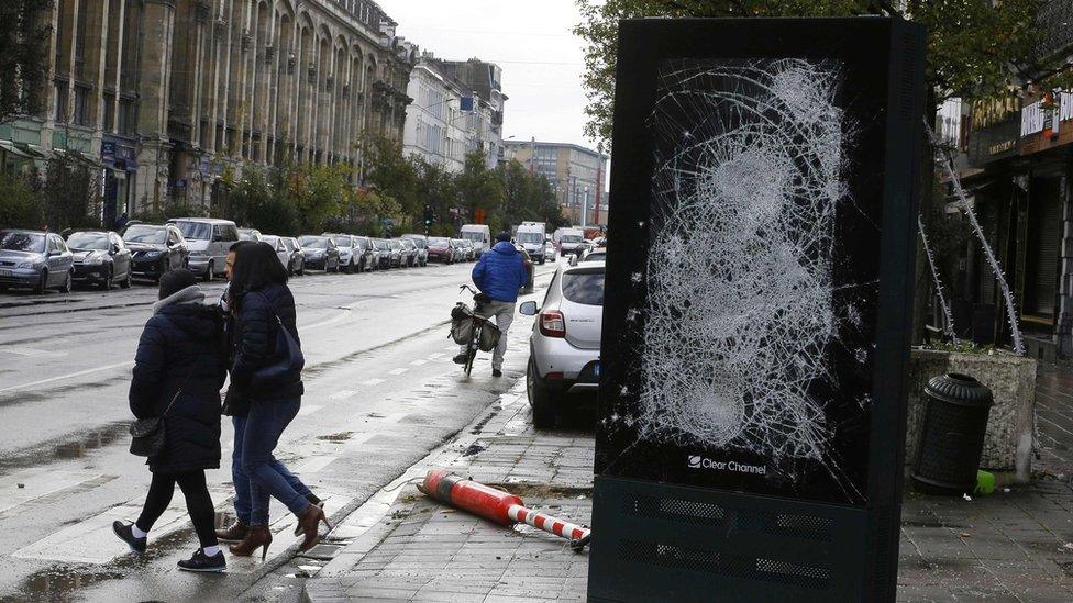 glass front of street ad smashed