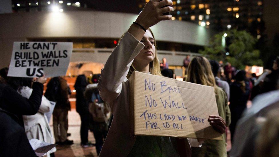 People attend a rally and candlelight vigil in Los Angeles, California