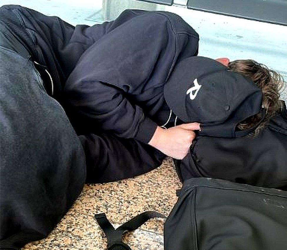 man lying on the terminal floor