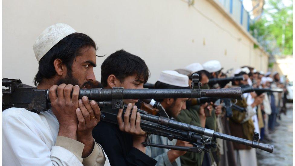 Taliban fighters hold their weapons before surrendering them to Afghan authorities in Jalalabad, east of Kabul