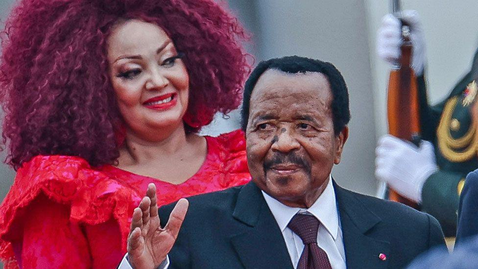 Cameroon's President Paul Biya waves as he arrives at Beijing Capital International Airport in Beijing, China. His wife Chantal is seen behind him - 4 September 2024