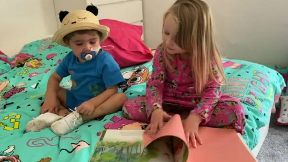 Stanley Dalton with his sister Delilah, as she reads him a book