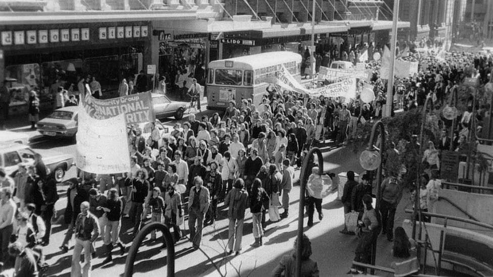 Marchers walk down a street during the 1978 Mardi Gras and Gay Solidarity Group protests in Sydney