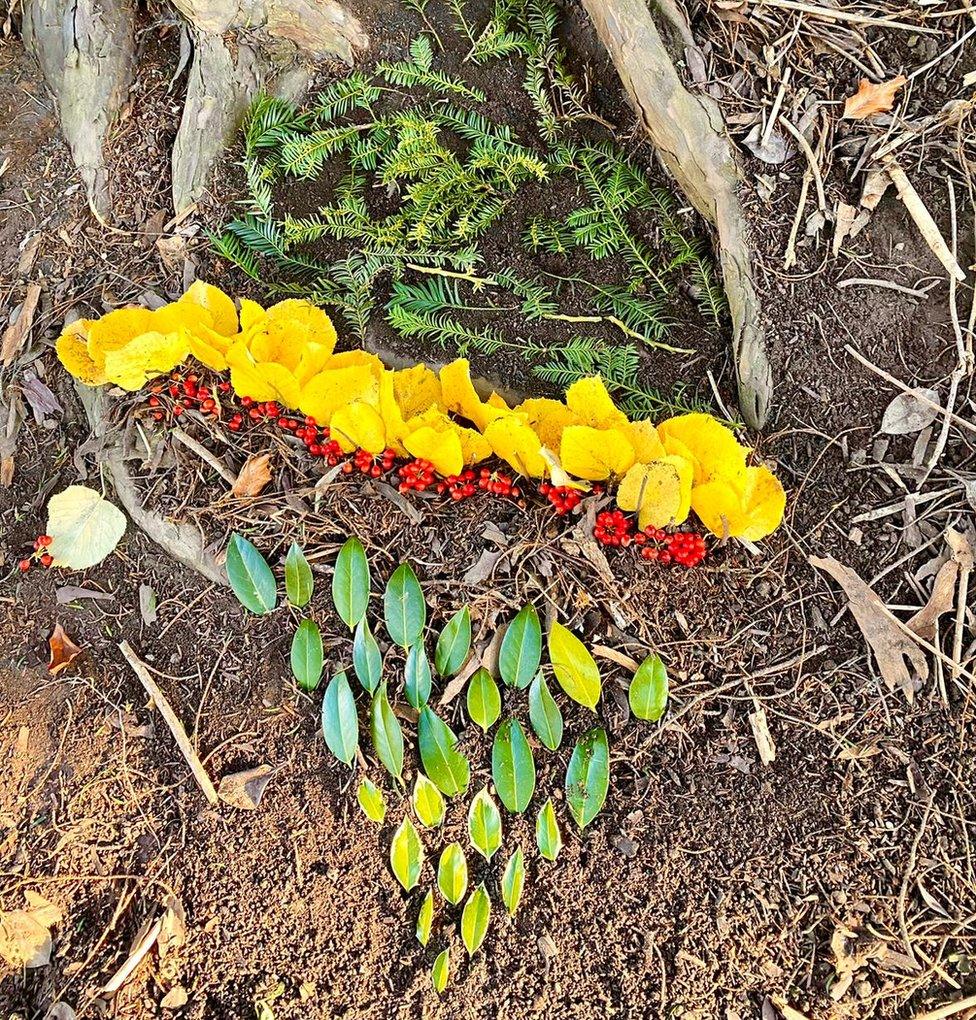 A land sculpture including leaves and berries