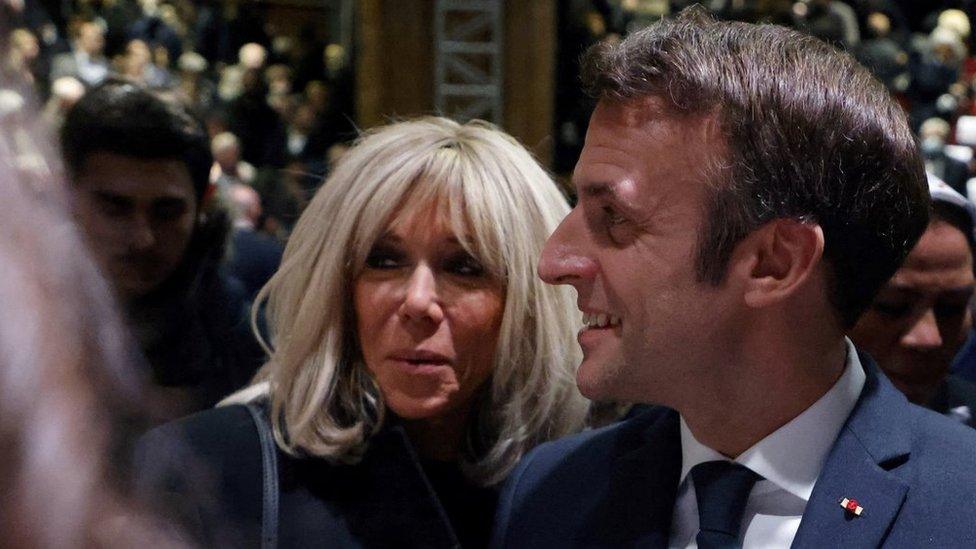 French President Emmanuel Macron flanked by his wife Brigitte Macron, meets Toulouse"s Jewish community members at the end of a tribute ceremony