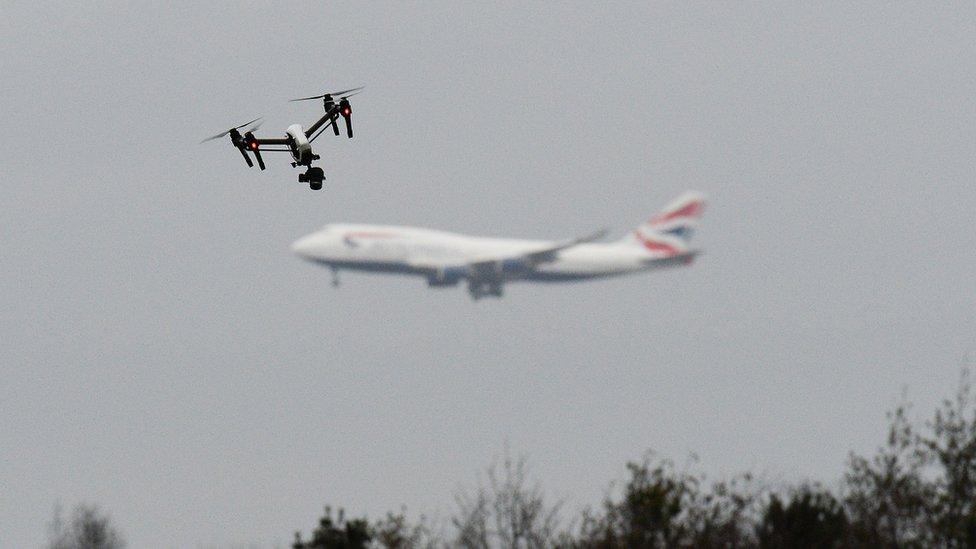 Drone flies in foreground as British Airways plane can be seen in the background