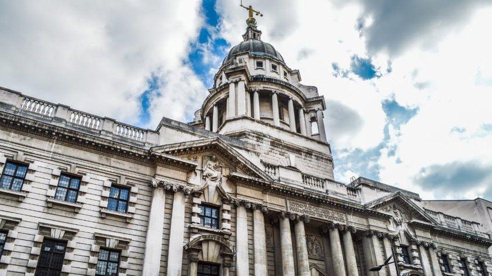 The Old Bailey Court in London seen from the outside. The sky is broken up with white clouds