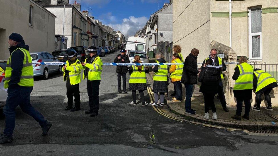 Officials at the edge of the cordon