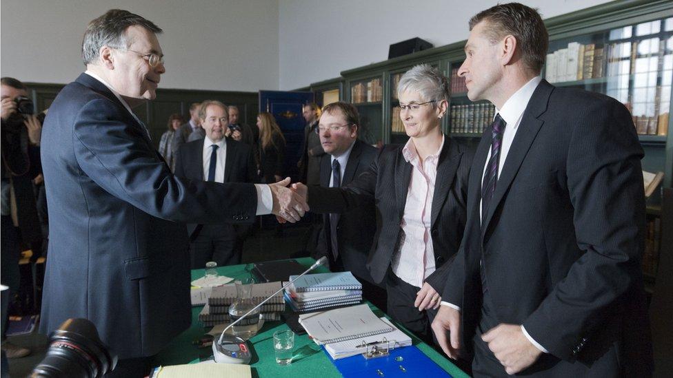 Iceland's ex-prime minister Geir Haarde shakes hands with Parliament prosecutor Sigridur Fridjonsdottir on March 5, 2012.