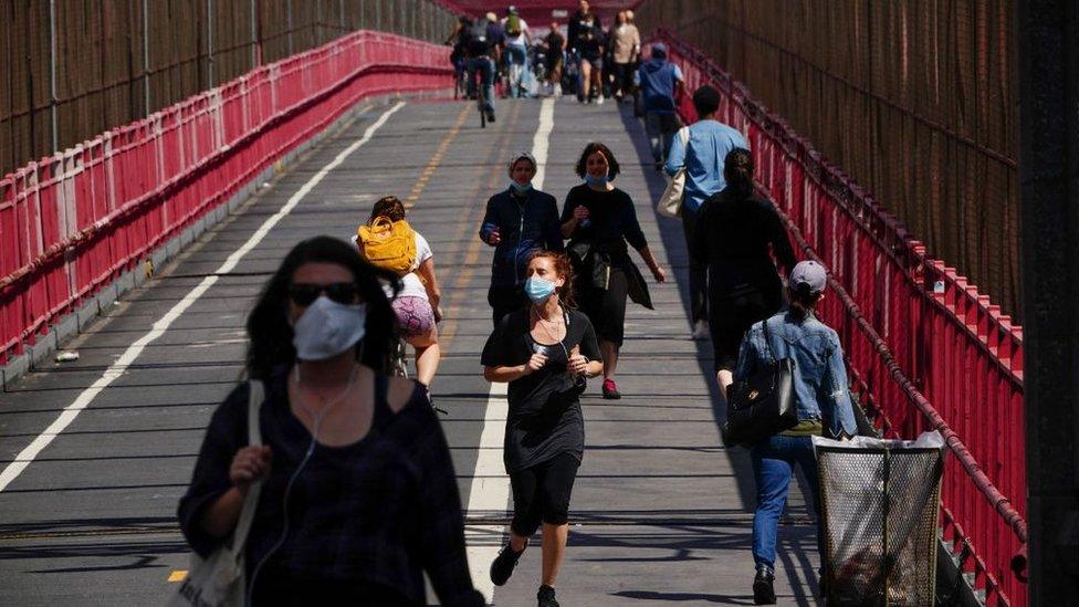 People crossing the Williamsburg bridge in New York wearing face masks