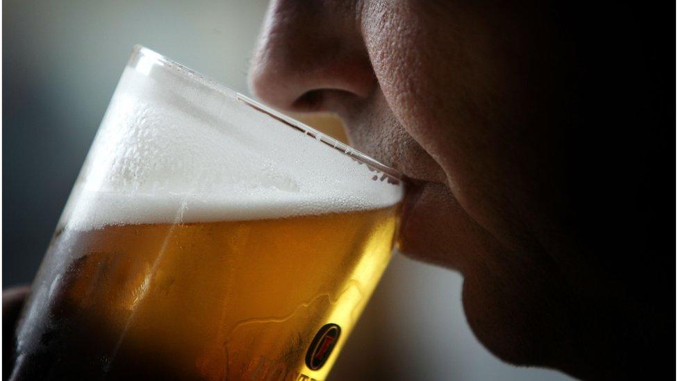 man drinking pint