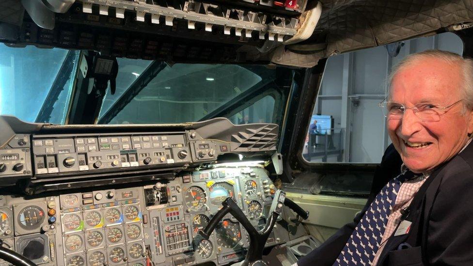 Colin Morris sitting in the cockpit of a flight simulator