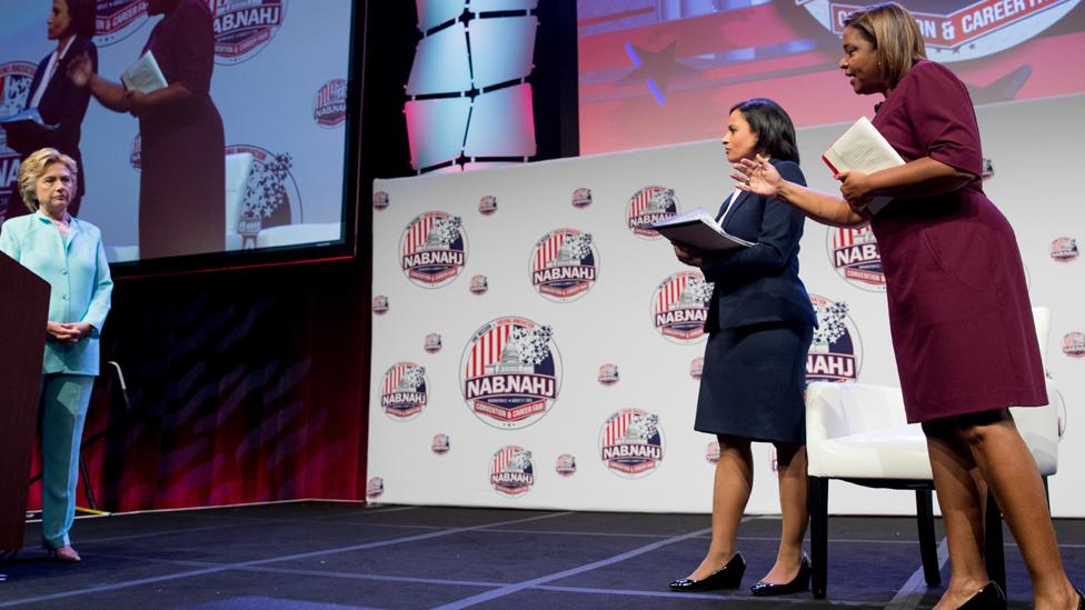 Telemundo reporter Lori Montenegro, right, accompanied by NBC reporter Kristen Welker, second from right, asks Democratic presidential candidate Hillary Clinton a question at the 2016 National Association of Black Journalists" and National Association of Hispanic Journalists" Hall of Fame Luncheon at Marriott Wardman Park in Washington, Friday, Aug. 5, 2016