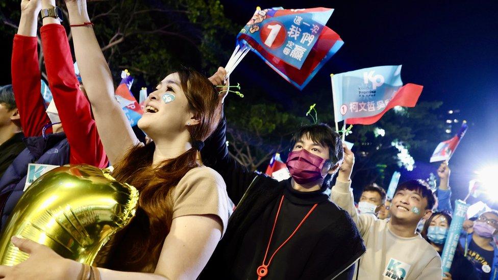 Supporters of Taiwan People's Party (TPP) presidential candidate Ko Wen-je (not pictured) chant slogans during a campaign rally in Kaohsiung city, Taiwan