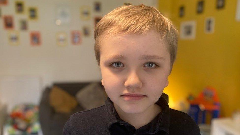 blonde boy looking at camera