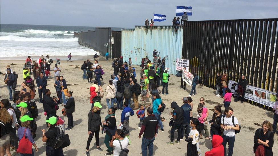 Protesters gather at the US-Mexico border fence at a beach in Tijuana, Mexico, 29 April 2018