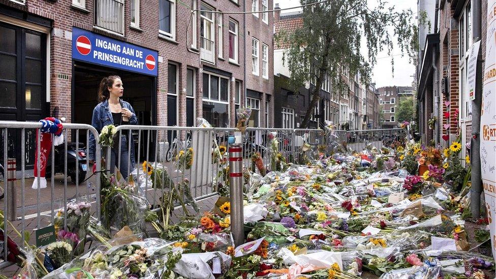 Flowers mark spot where d Vries was shot, central Amsterdam, 12 Jul 21