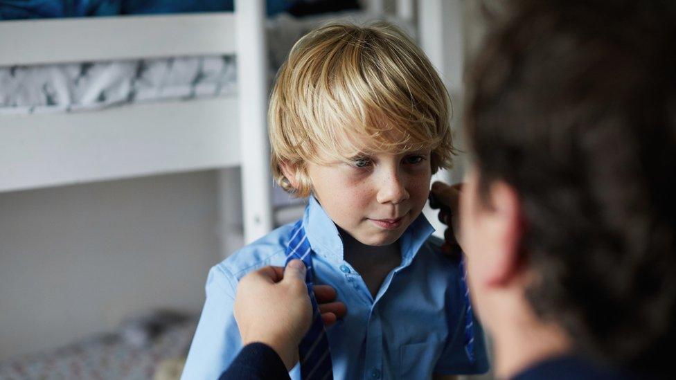 boy-being-dressed-for-school.