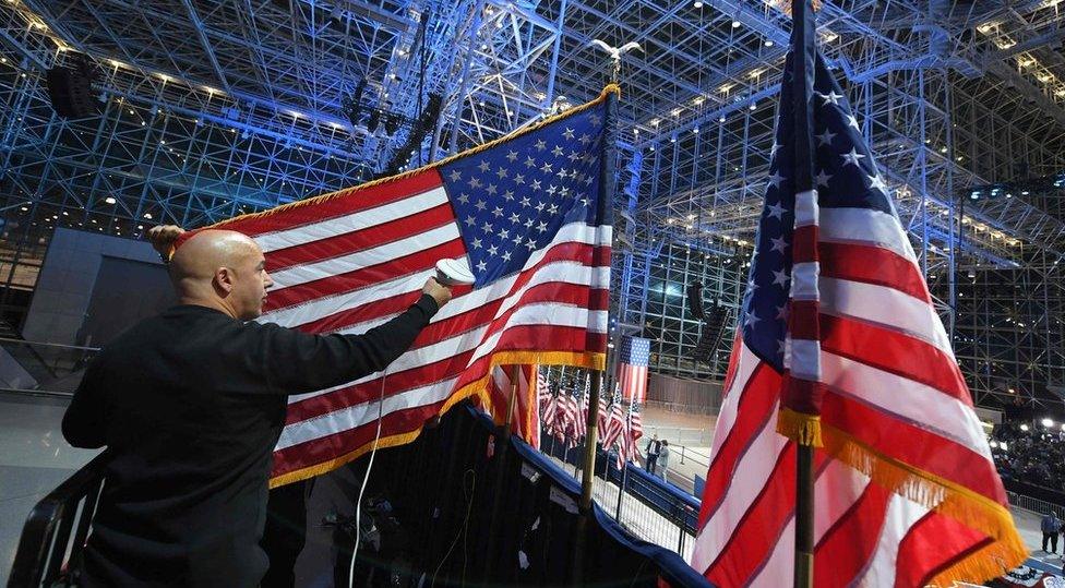 A worker prepares a US flag at the Jacob K Javits Convention Center in New York